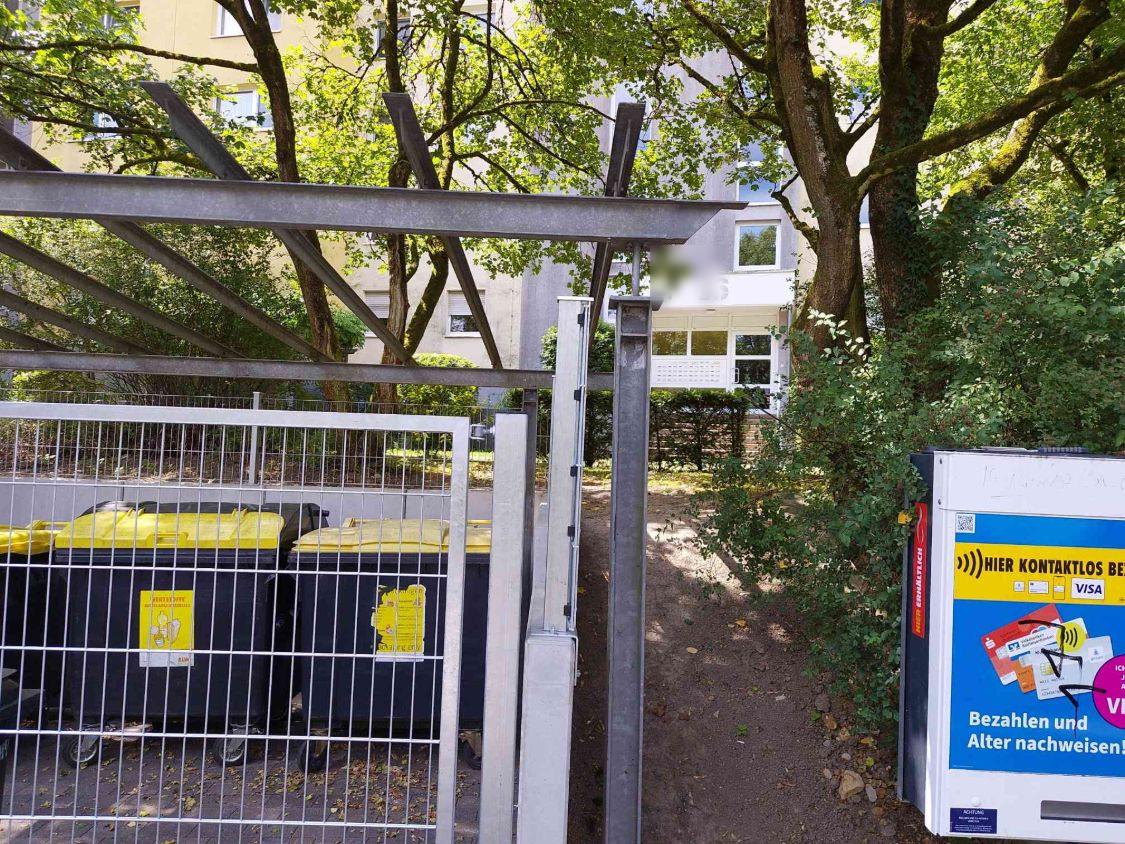 Schmaler Durchgang zwischen Torpfosten und Hecke zum Hauseingang